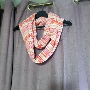 A pink and white infinity scarf